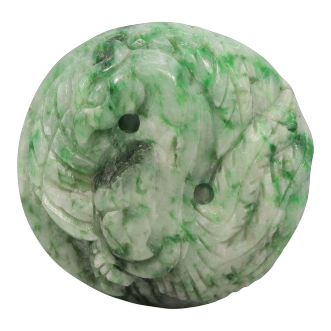 A Chinese Jadeite Jade Amulet Pendant, 20th Century, 18ZL: Carved from pale green jadeite jade with natural green inclusions distributed throughout the matrix, the pendant is formed as a circular object with a relief-carved phoenix motif on the exterior surfa