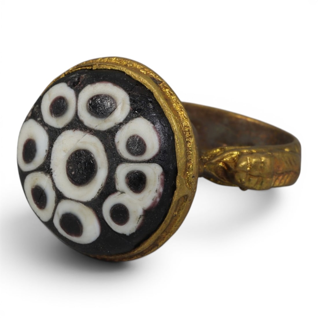 Antique Qajar Dynasty Gilt Evil Eye Ring, US Size 8.5, 39AJ: A gilt-metal ring of the Qajar period, US ring size 8.5, featuring a large domed evil-eye glass inlay with a striking multi-eye pattern (one large central eye surrounded by eight smaller eyes) in blac