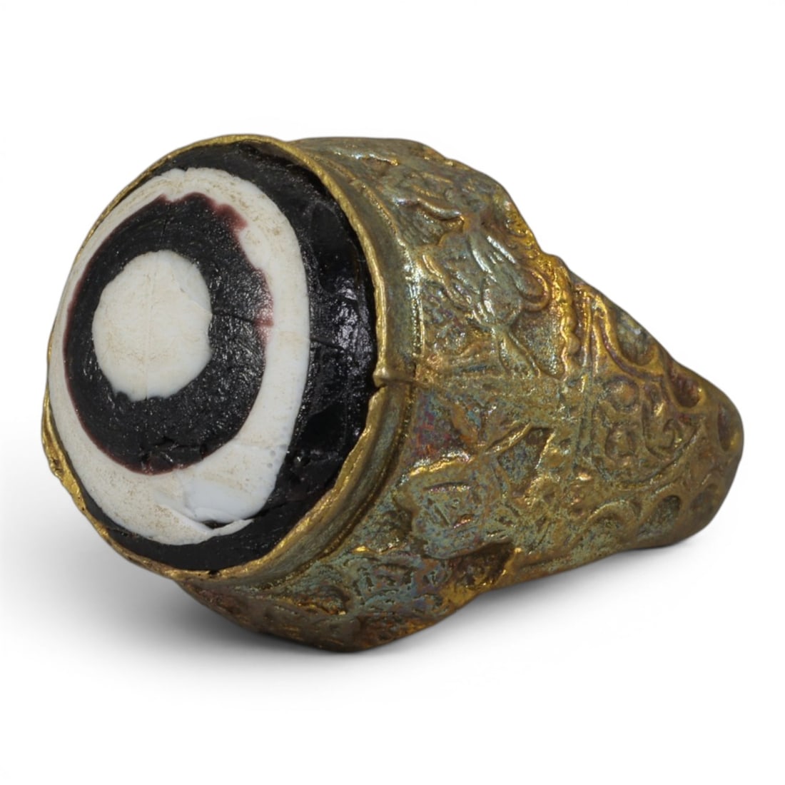 Antique Qajar Dynasty Gilt Evil Eye Ring, US Size 8.5, 20AJ: A gilt-metal ring of the Qajar period, US ring size 8.5, featuring a large domed evil-eye glass inlay with a bold concentric black-and-white design (the glass exhibits age-related cracks). The bezel a