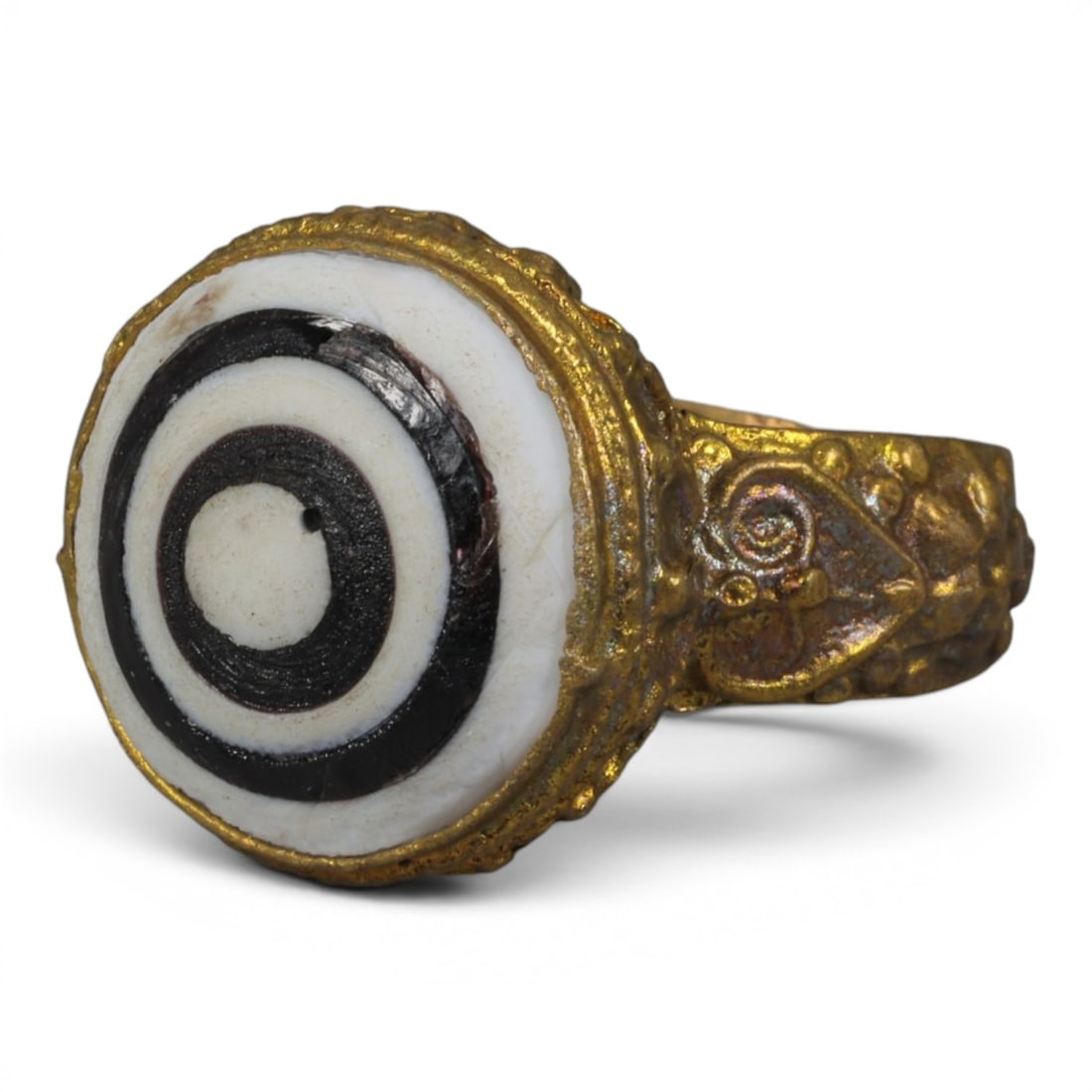 Antique Qajar Dynasty Gilt Evil Eye Ring, US Size 9, 38AJ: A gilt-metal ring of the Qajar period, US ring size 9, featuring a large domed evil-eye glass inlay with a striking concentric black-and-white pattern. The glass exhibits age-related cracks consistent