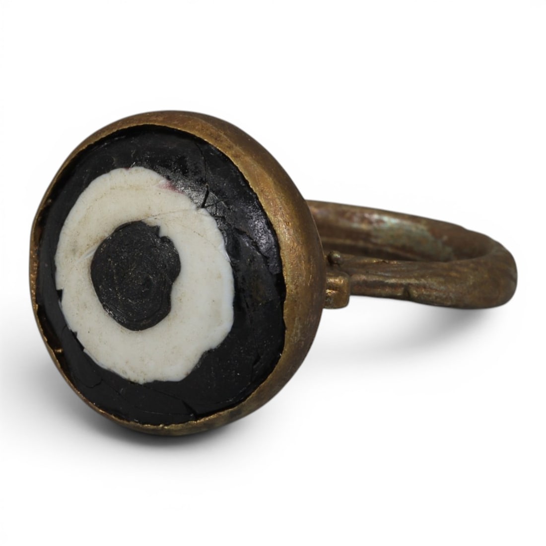 Antique Qajar Dynasty Gilt Evil Eye Ring, US Size 8, 37AJ: A gilt-metal ring of the Qajar period, US ring size 8, featuring a large domed evil-eye glass inlay with a bold concentric black-and-white design (the glass exhibits age-related cracks). The domed bez