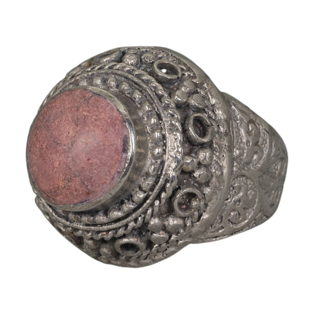 A Middle Eastern Silver Plated Rhodonite Ring, Late 19th-Early 20th Century, 21AK: The ring is centered with a round cabochon rhodonite stone exhibiting soft pink tones and natural surface veining, set within an ornate domed bezel decorated with beaded granulation, twisted wirework,