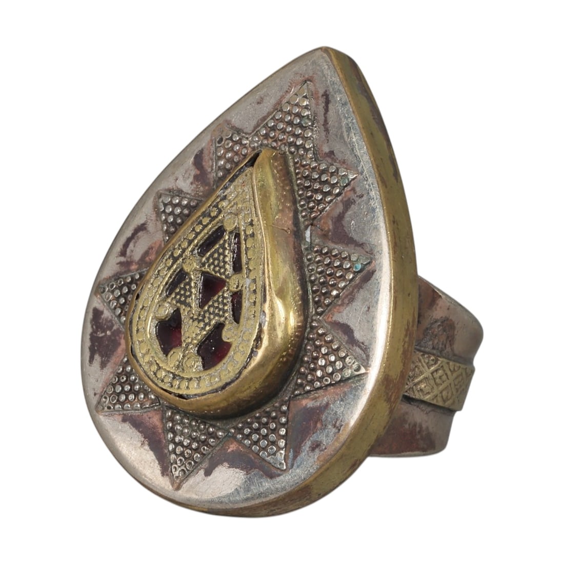 A Central Asian Silver Plated Ring, Late 19th-Early 20th Century, 7AK: Constructed from silver plated base metal with brass and copper accents, the ring features a large teardrop-shaped bezel. The central motif consists of a brass teardrop form with openwork detailing, s