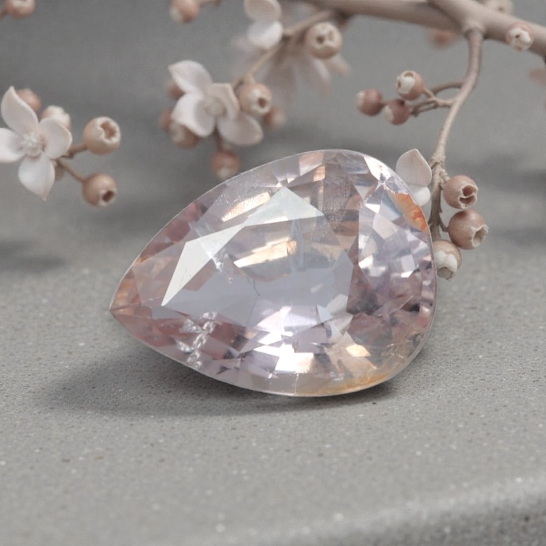 0.77 Carats Natural Sri Lankan Padparadscha Sapphire Pear Cut, 28AL: This pear-cut natural padparadscha sapphire showcases a delicate, dreamy blend of soft pink and warm orange hues, evoking the serene glow of a sunset sky. The faceted cut features well-proportioned fa