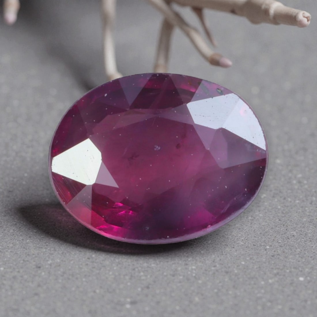 1.05 Carats Natural Pinkish Red Mozambique Ruby Oval Cut, 99AK: This oval-cut natural ruby presents a rich, saturated pinkish-red hue, with subtle tonal variations that add organic depth and warmth to its appearance. The faceted cut features well-proportioned face