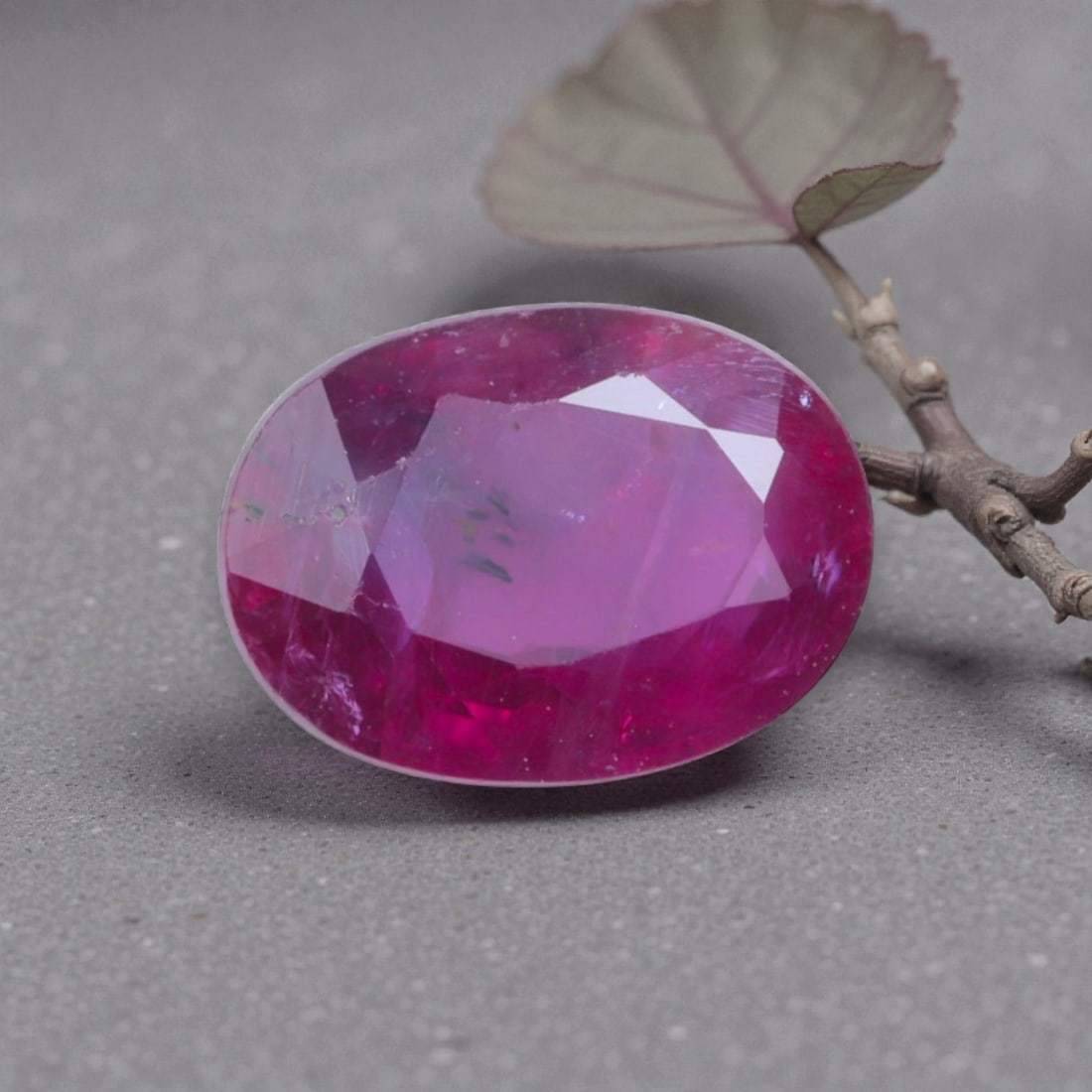 1.23 Carats Natural Pinkish Red Mozambique Ruby Oval Cut, 11AL: This oval-cut natural ruby presents a rich pinkish-red hue with soft purple undertones, featuring subtle natural inclusions and internal characteristics that add organic depth and warmth to its appear