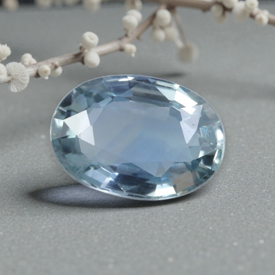 1.14 Carats Natural Australian Light Blue Sapphire Oval Cut, 35AL: This oval-cut natural sapphire showcases a delicate, serene light blue hue, reminiscent of a clear sky on a calm day. The faceted cut features well-proportioned facets that create brilliant light play