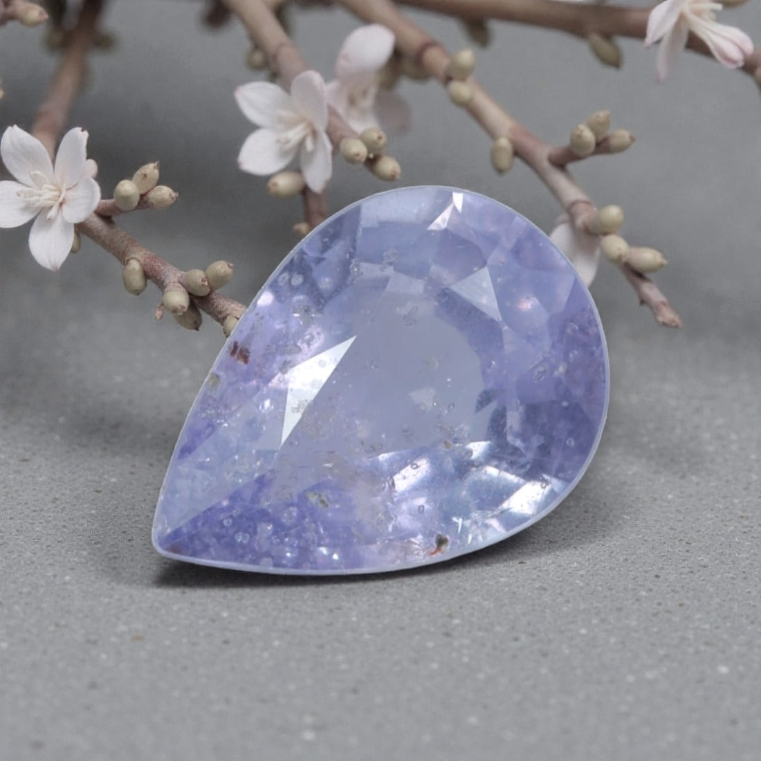 0.94 Carats Natural Sri Lankan Lavender Sapphire Pear Cut, 46AL: This pear-cut natural lavender sapphire showcases a soft, dreamy pale purple hue, reminiscent of twilight skies and blooming lavender fields. The faceted cut features well-proportioned facets that cre