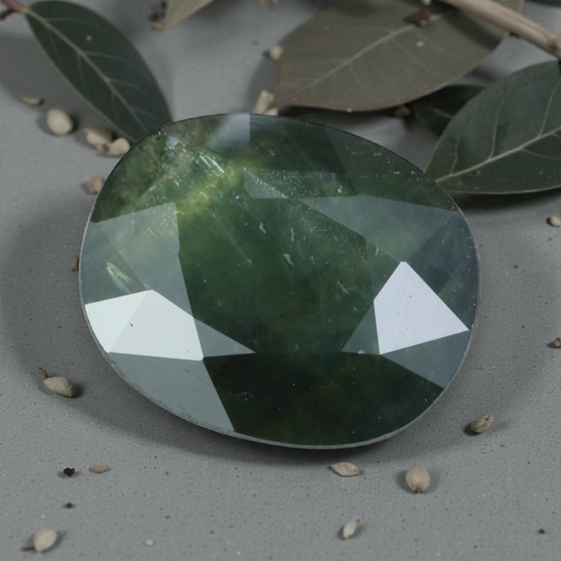 2.25 Carats Natural Australian Green Sapphire Oval Cut, 36AL: This oval-cut natural green sapphire showcases a rich, earthy forest green hue, evoking the depth of Australian rainforests. The faceted cut features well-proportioned facets that create gentle light 