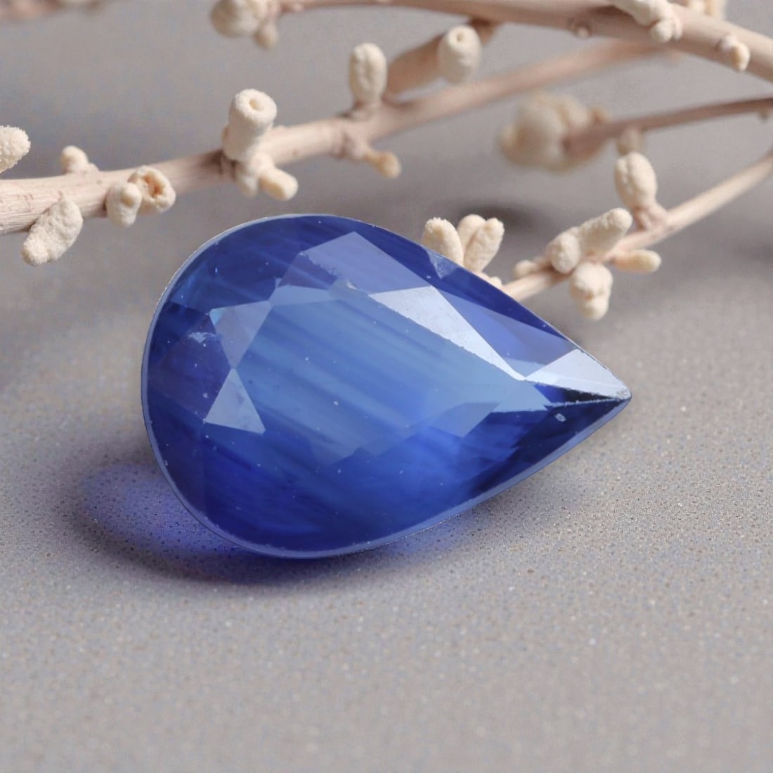 0.75 Carats Natural Cornflower Blue Madagascar Sapphire Pear Cut, 80AL: This pear-shaped Madagascar blue sapphire exhibits a soft, luminous cornflower blue hue, with subtle natural banding that adds organic depth to its color. The faceted cut is polished to a high standar
