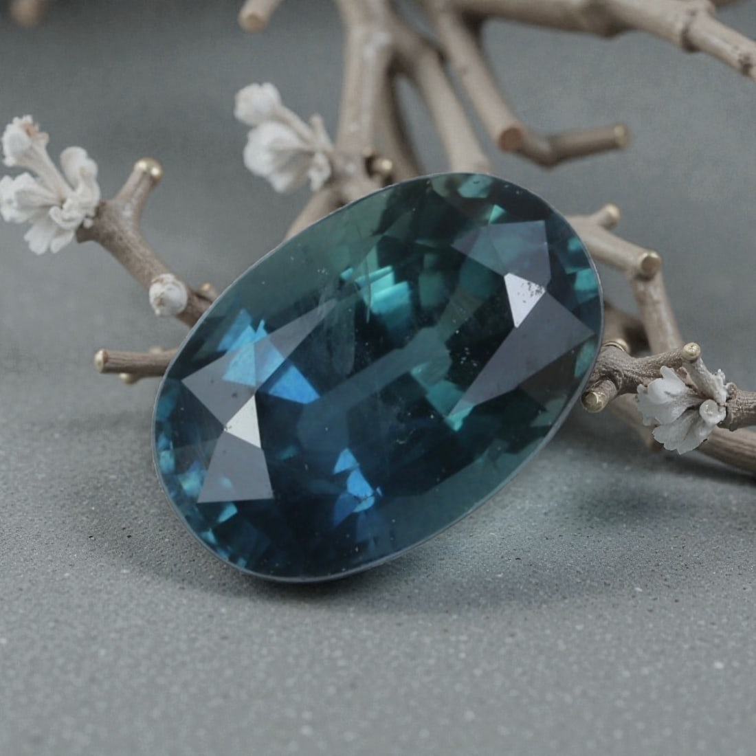 0.91 Carats Natural Australian Teal Sapphire Oval Cut, 33AL: This oval-cut natural sapphire displays a deep, captivating teal hue, with subtle color variations that shift beautifully under light. The faceted cut features well-proportioned facets that create bri