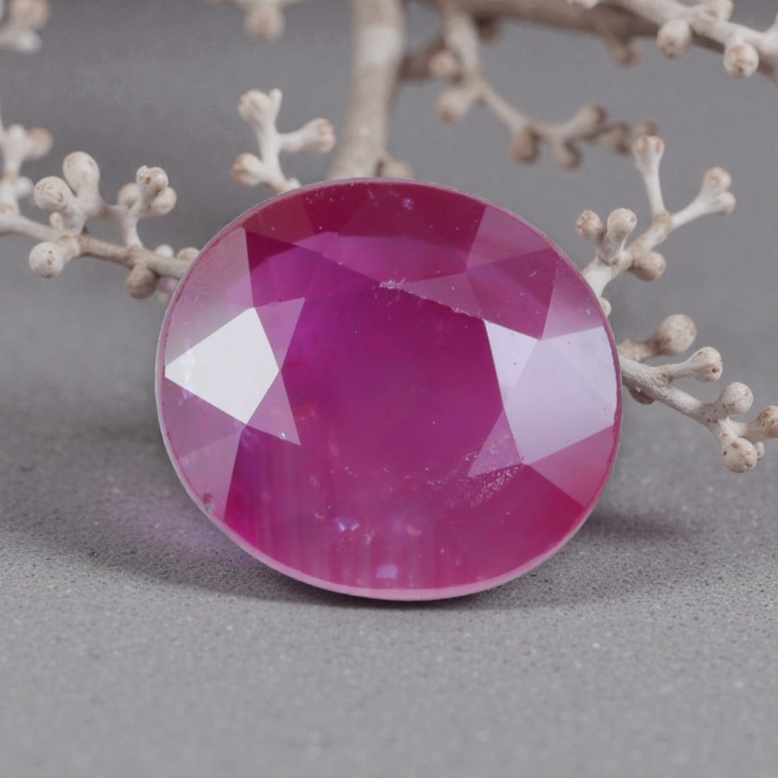 1.62 Carats Natural Pinkish Red Mozambique Ruby Round Cut, 10AL: This round-cut natural ruby presents a soft pinkish-red hue with delicate tonal variations, featuring subtle natural inclusions and faint internal characteristics that add organic depth and warmth to 