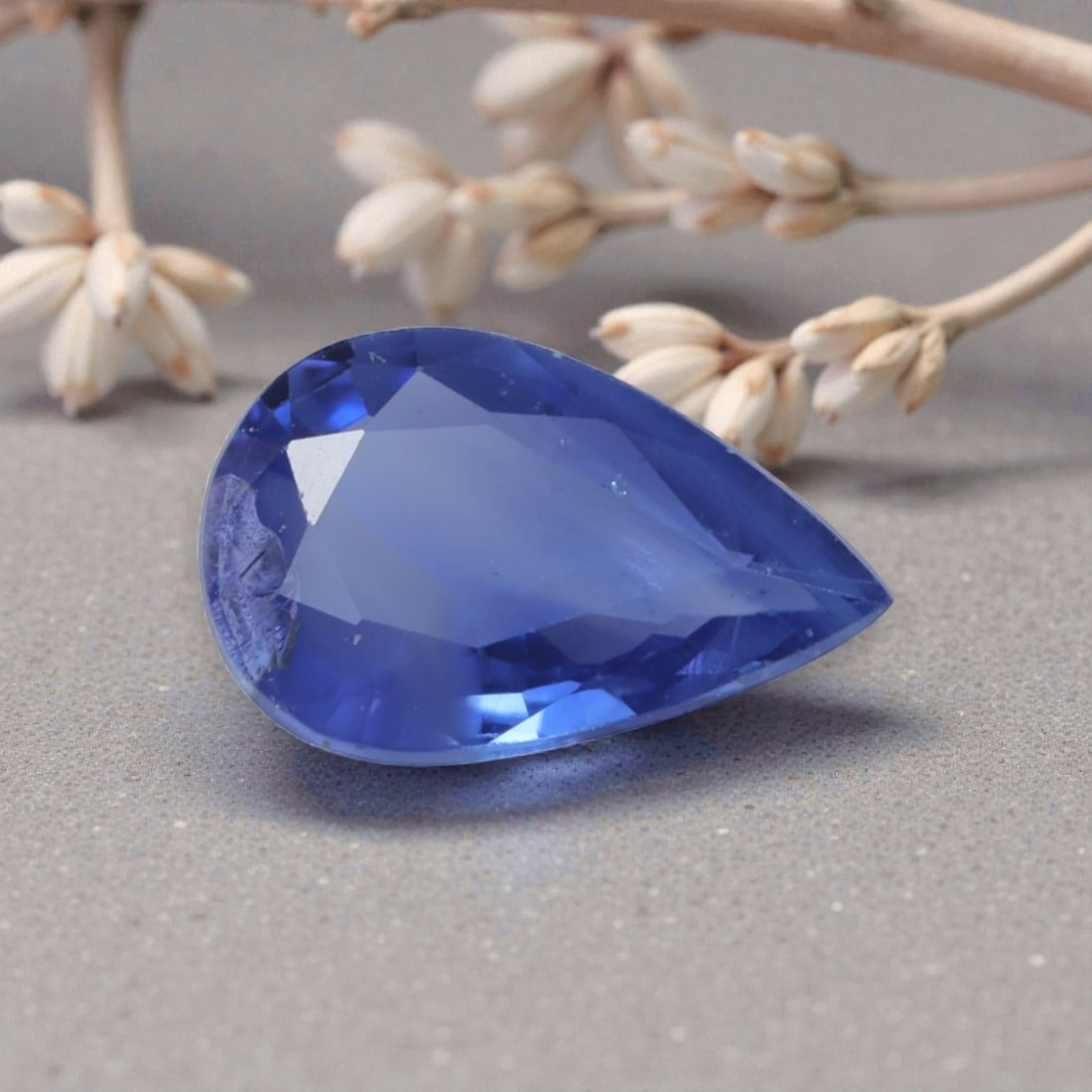 0.66 Carats Natural Cornflower Blue Madagascar Sapphire Pear Cut, 92AK: This pear-shaped Madagascar blue sapphire radiates with a soft, luminous cornflower blue hue, evoking the delicate, serene tones of a summer sky. The faceted cut is expertly polished, creating gentle 
