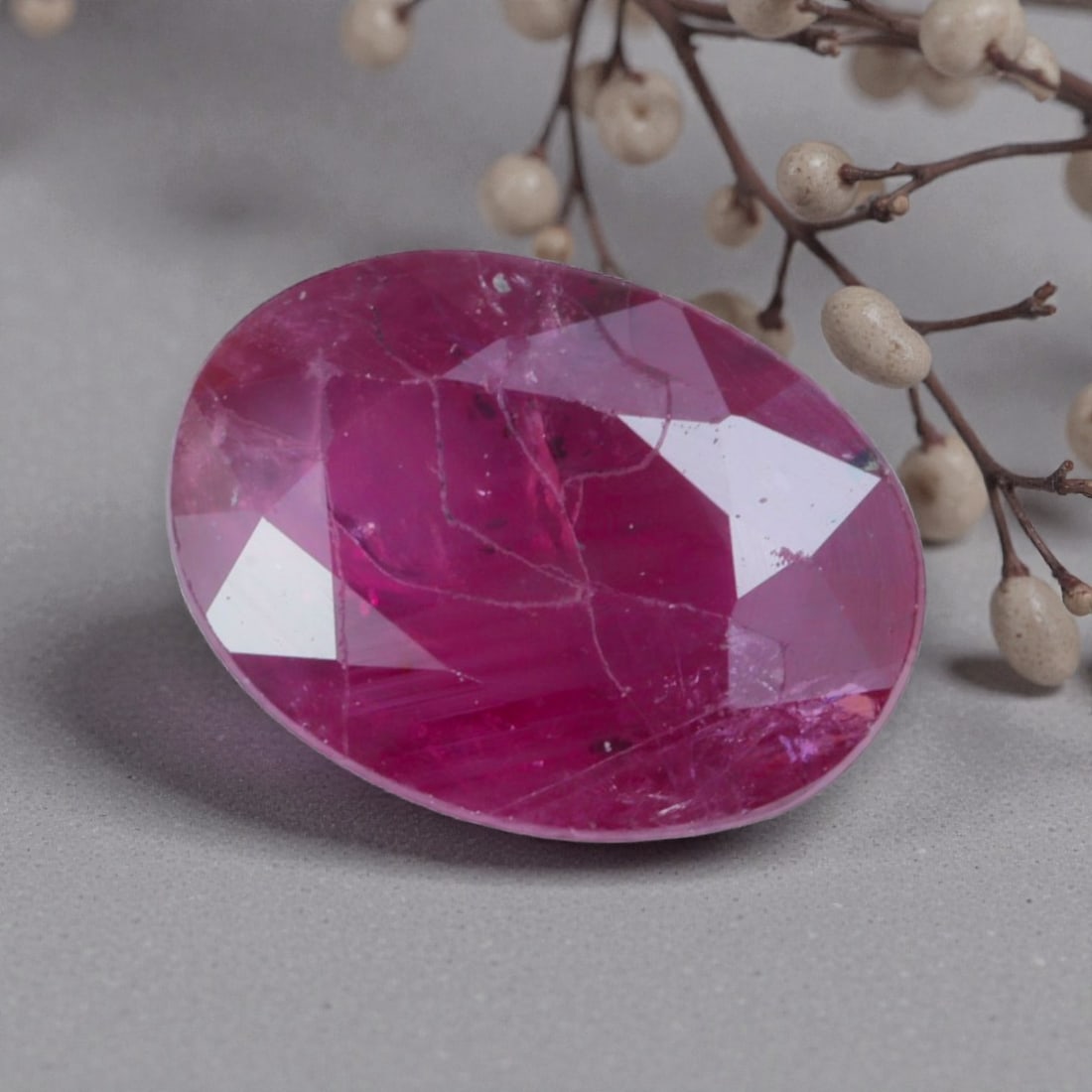 1.39 Carats Natural Pinkish Red Mozambique Ruby Oval Cut, 95AK: This oval-cut natural ruby showcases a rich pinkish-red hue with subtle purple undertones, featuring natural inclusions and faint internal characteristics that add organic depth and authenticity to it