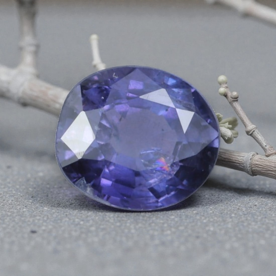 0.60 Carats Natural Sri Lankan Purple Sapphire Oval Cut, 27AL: This oval-cut natural purple sapphire showcases a rich, saturated violet hue, reminiscent of twilight skies and amethystine depths. The faceted cut features crisp, well-proportioned facets that create
