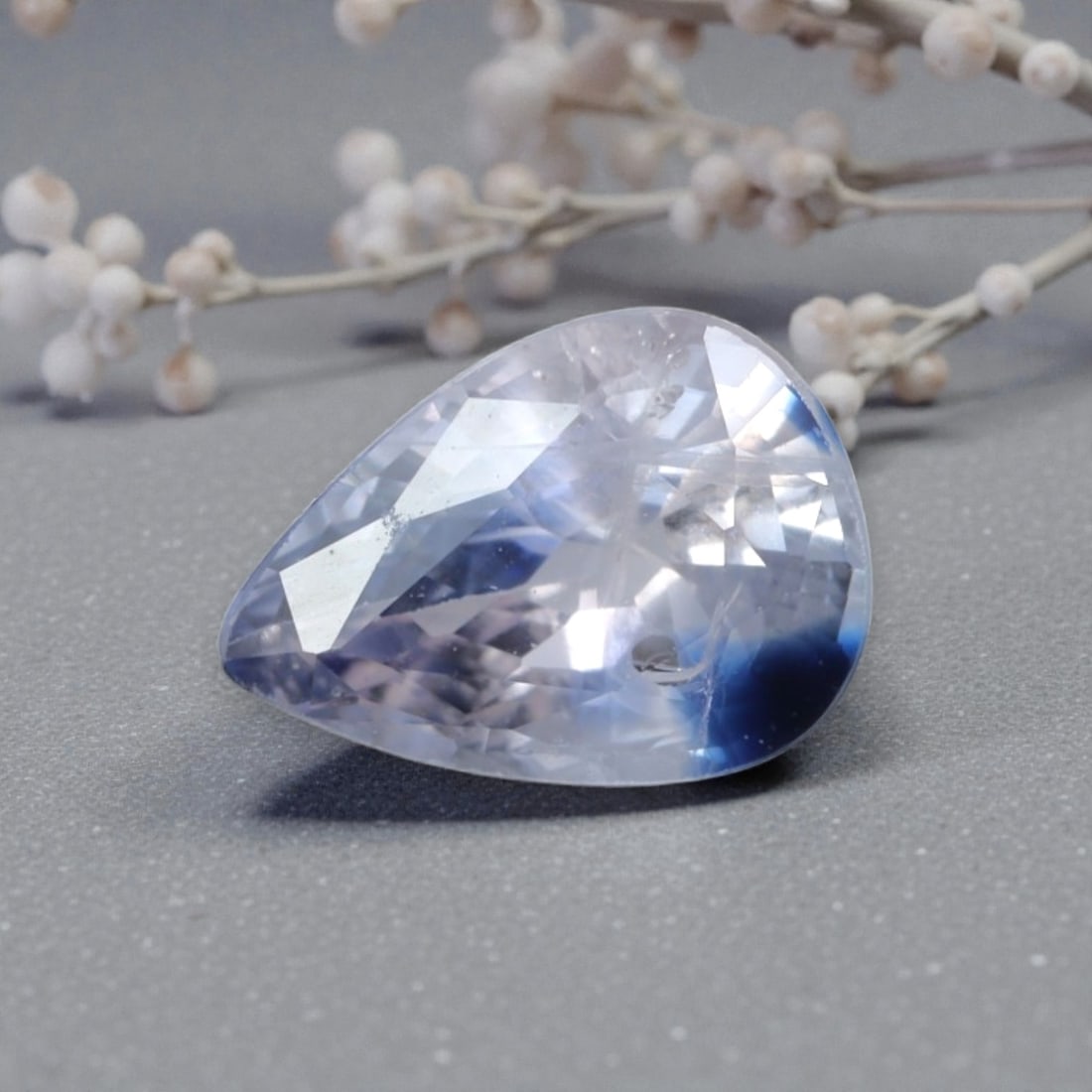 1.02 Carats Natural Sri Lankan Bi-Color Sapphire Pear Cut, 26AL: This pear-cut natural sapphire features a striking bi-color pattern, with a crisp, colorless to pale blue base that transitions into a vivid deep blue hue at one end. The faceted cut features well-pro