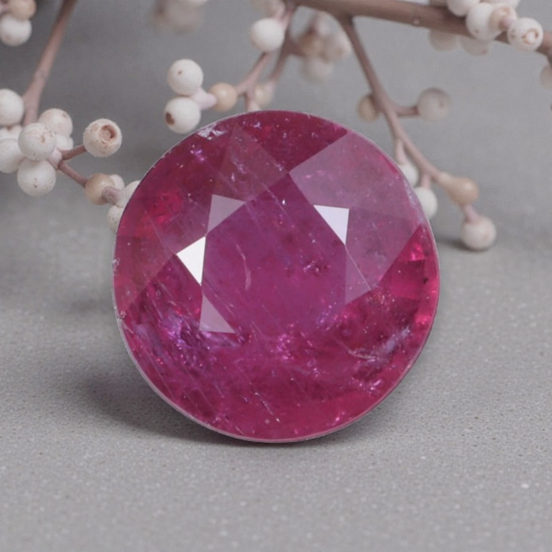 0.86 Carats Natural Mozambique Ruby Round Cut, 43AL: This round-cut natural ruby showcases a rich, vivid magenta-red hue, bursting with the fiery passion that defines fine rubies. The faceted cut features well-proportioned facets that create brilliant l