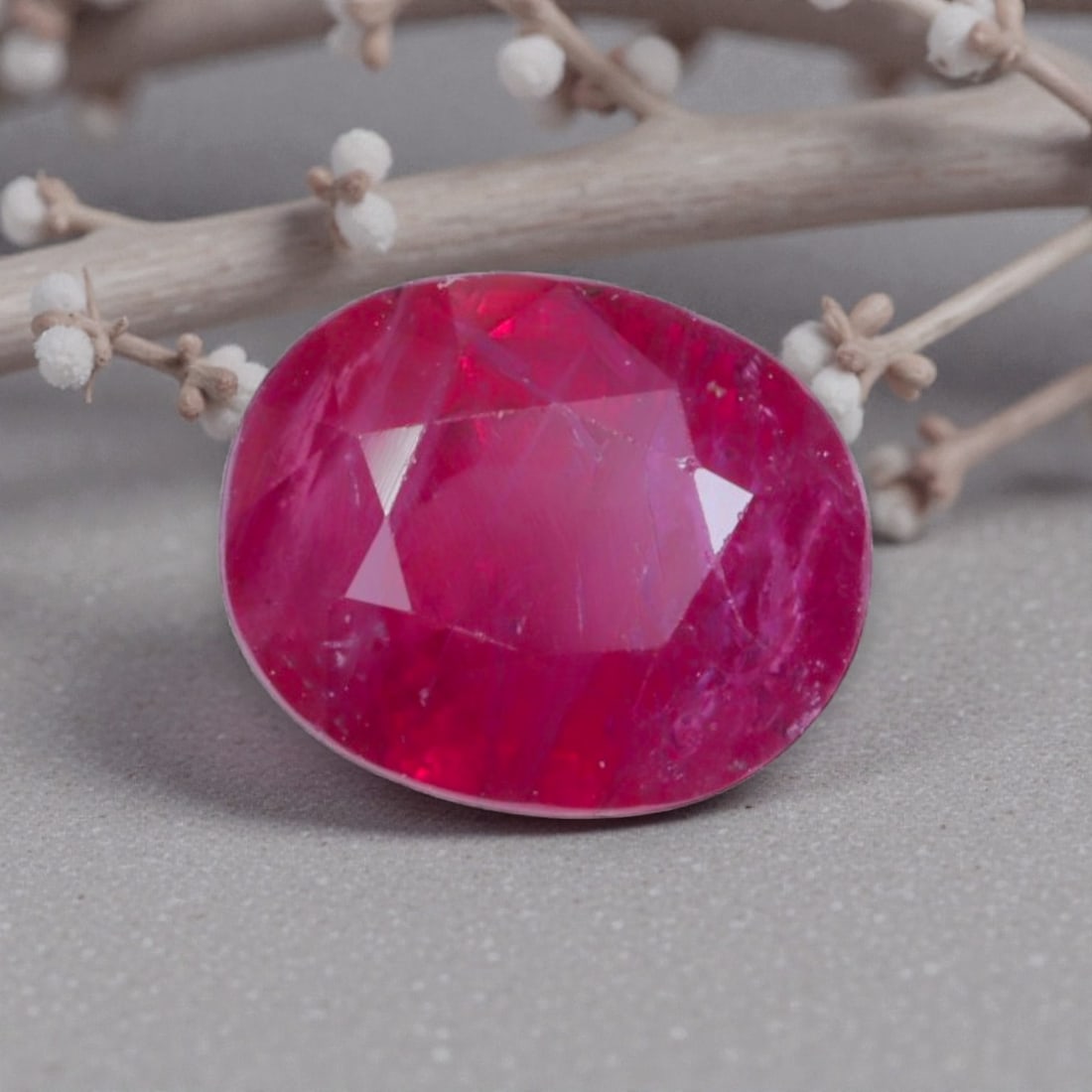 1.25 Carats Natural Vivid Red Mozambique Ruby Oval Cut, 5AL: This oval-cut natural ruby presents a striking vivid red hue, with subtle tonal variations and natural internal characteristics that add organic depth and vibrancy to its appearance. The faceted cut f