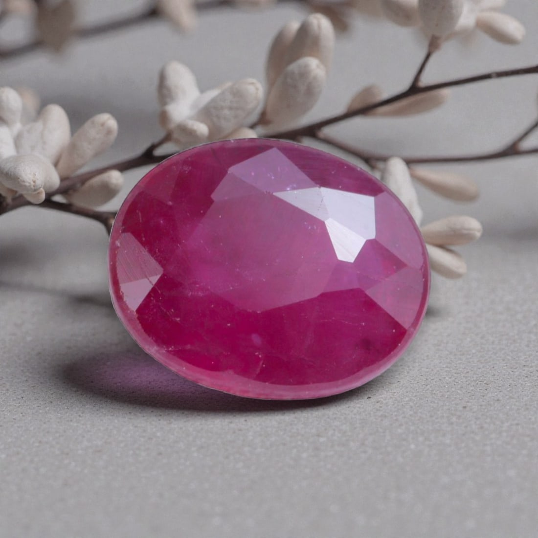 1.17 Carats Natural Pinkish Red Mozambique Ruby Oval Cut, 98AK: This oval-cut natural ruby showcases a vibrant pinkish-red hue, with soft tonal variations that add organic depth and warmth to its appearance. The faceted cut features well-proportioned facets that c