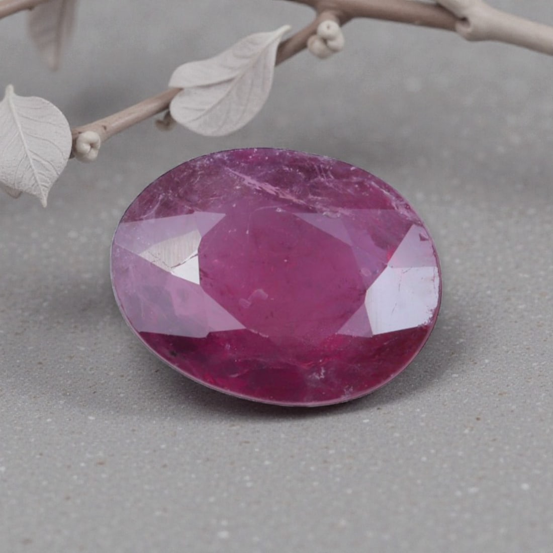 0.78 Carats Natural Pinkish Red Mozambique Ruby Oval Cut, 7AL: This oval-cut natural ruby showcases a rich pinkish-red hue with subtle purple undertones, featuring natural inclusions and faint internal characteristics that add organic depth and authenticity to it