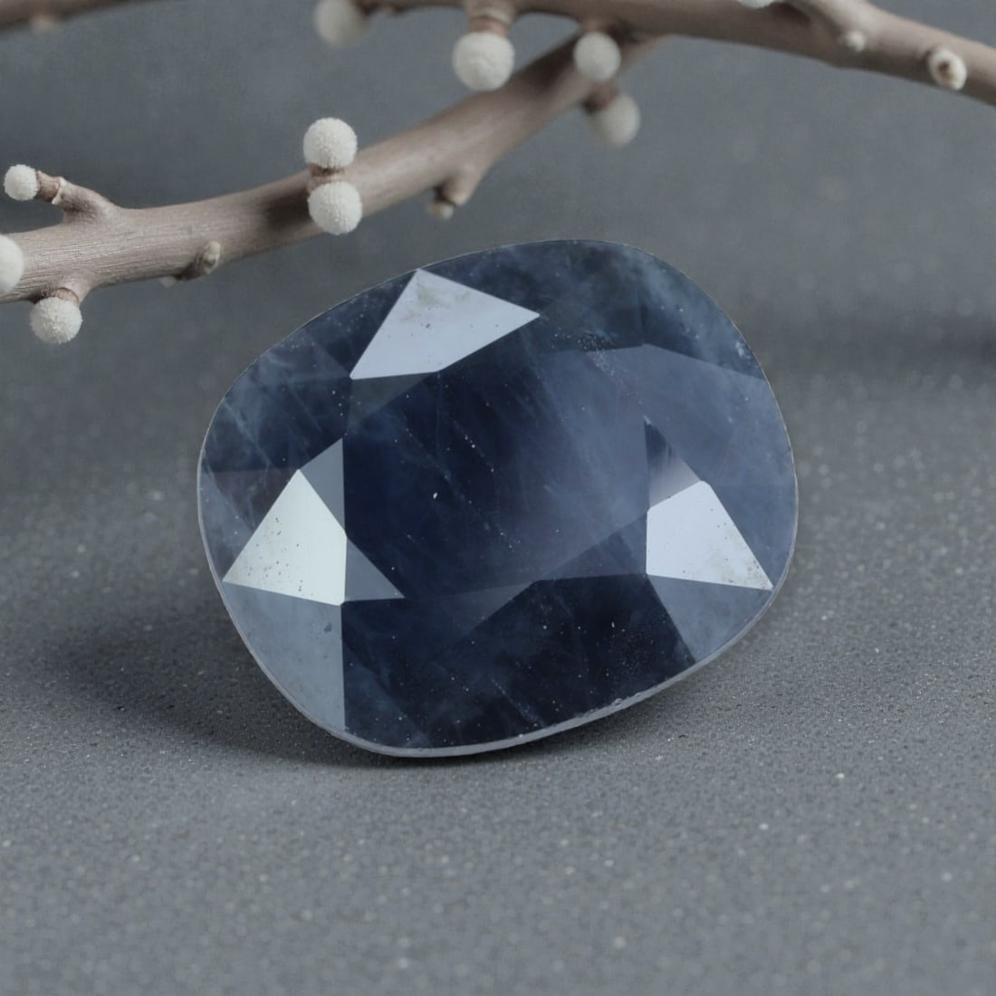 4.79 Carats Natural Madagascar Blue Sapphire Cushion Cut, 41AL: This cushion-cut natural blue sapphire showcases a deep, moody navy hue with subtle grey undertones, evoking the quiet mystery of the night sky over Madagascar's coastlines. The faceted cut features s