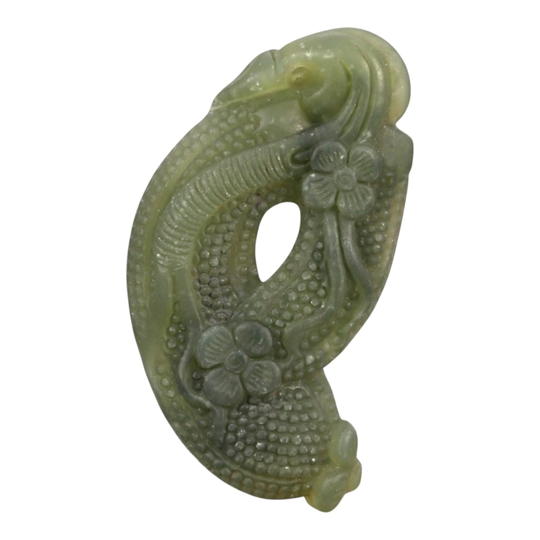 A Chinese Nephrite Jade Fruit Pendant, 20th Century, 77FA: Carved from greenish celadon nephrite jade with areas of darker tonal variation and soft translucency, the pendant is worked in the form of an elongated fruit with curling vine and floral motifs. The 