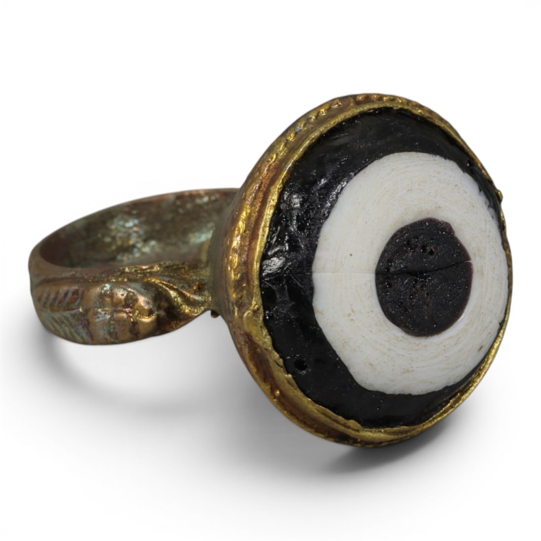 Antique Qajar Dynasty Gilt Evil Eye Ring, US Size 8, 41AJ: A gilt-metal ring of the Qajar period, US ring size 8, featuring a large domed evil-eye glass inlay with concentric black, white, and dark central layers. The bezel is decorated with embossed foliate 