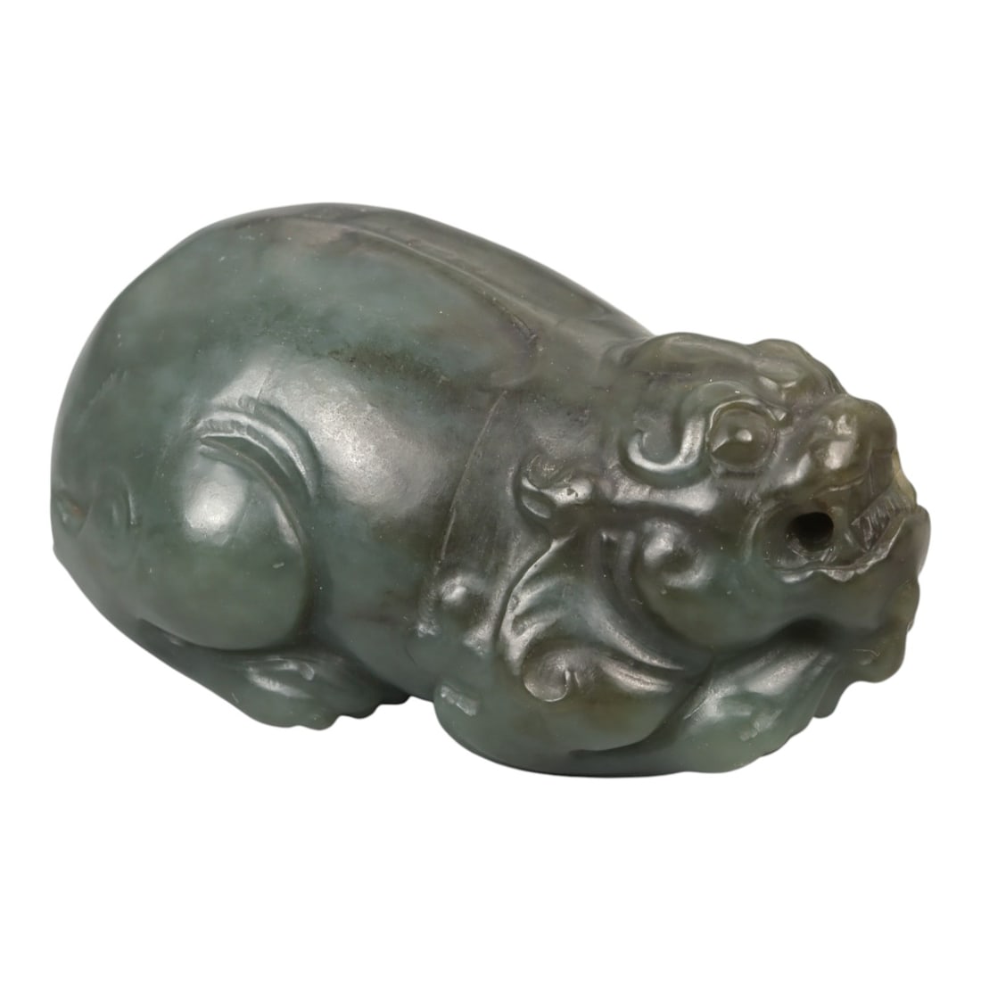 A Chinese Nephrite Jade Pixiu Figure, 20th Century, 66YA: Carved from green nephrite jade with areas of darker saturation and soft translucency, the figure represents pixiu, the mythical beast associated with protection and the attraction of wealth. The crea