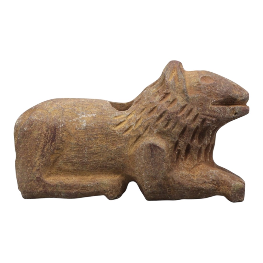 Ancient Stone Lion Amulet - Near Eastern Recumbent, 42ZR: Carved from warm tan-hued stone with a matte, weathered patina, executed in a stylized recumbent form characteristic of Near Eastern zoomorphic amulet craft. The figure depicts a lion in a resting pos