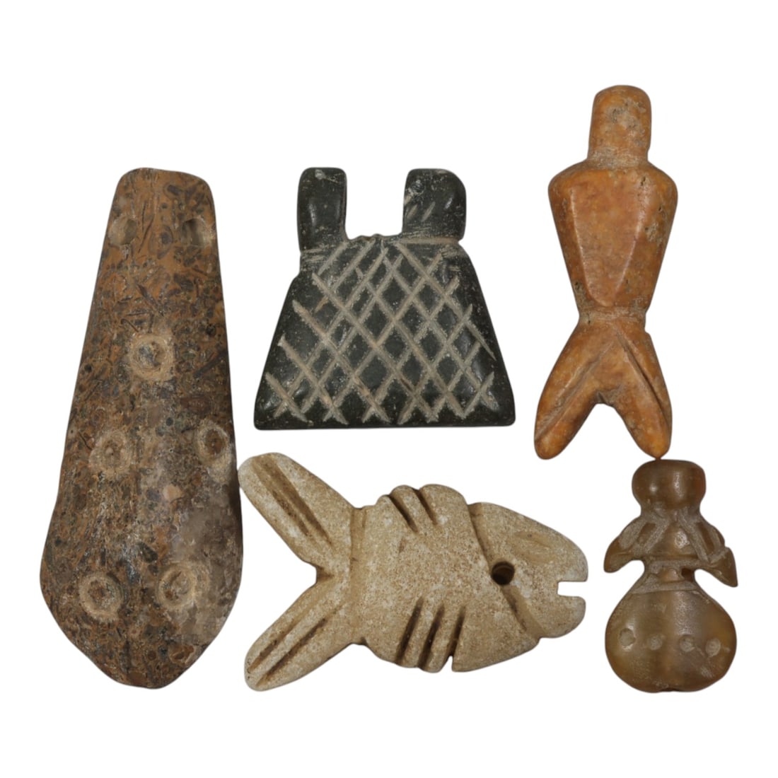 Lot of 5 Ancient Coptic Egyptian Stone Amulets, Circa Roman to Coptic Era, 99WP: Carved from various stones, including brown fossiliferous, dark green, tan, light beige, and translucent brown varieties, the group consists of five distinct amulets. The set includes a cone-shaped pe