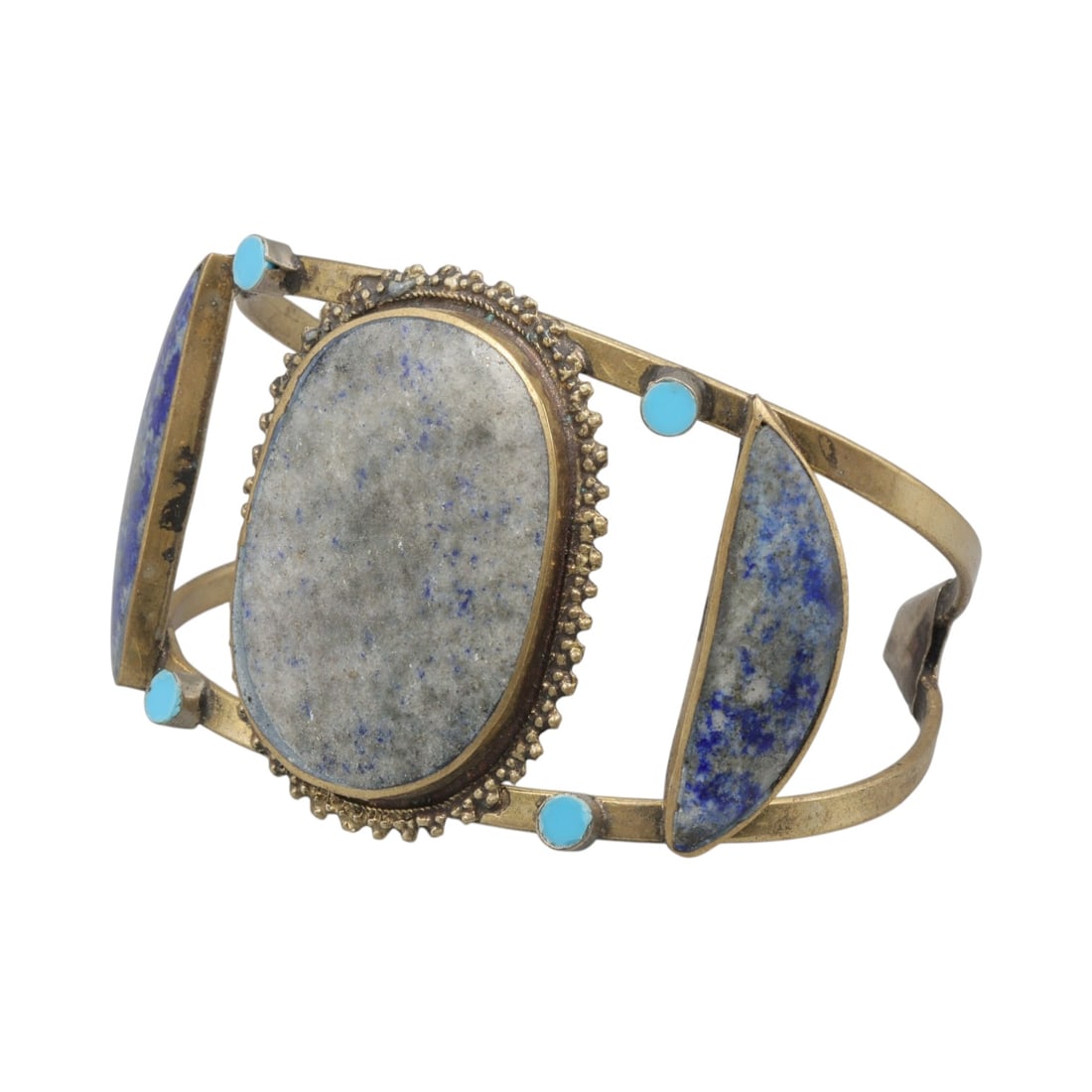 A Vintage Himalayan Lapis Lazuli Stone Inlay Cuff Bracelet, 25AH: A handcrafted vintage cuff bracelet, measuring approximately 8 cm in width, featuring traditional Himalayan jewelry design. The piece has a brass-toned metal base, showcasing a large oval central ston