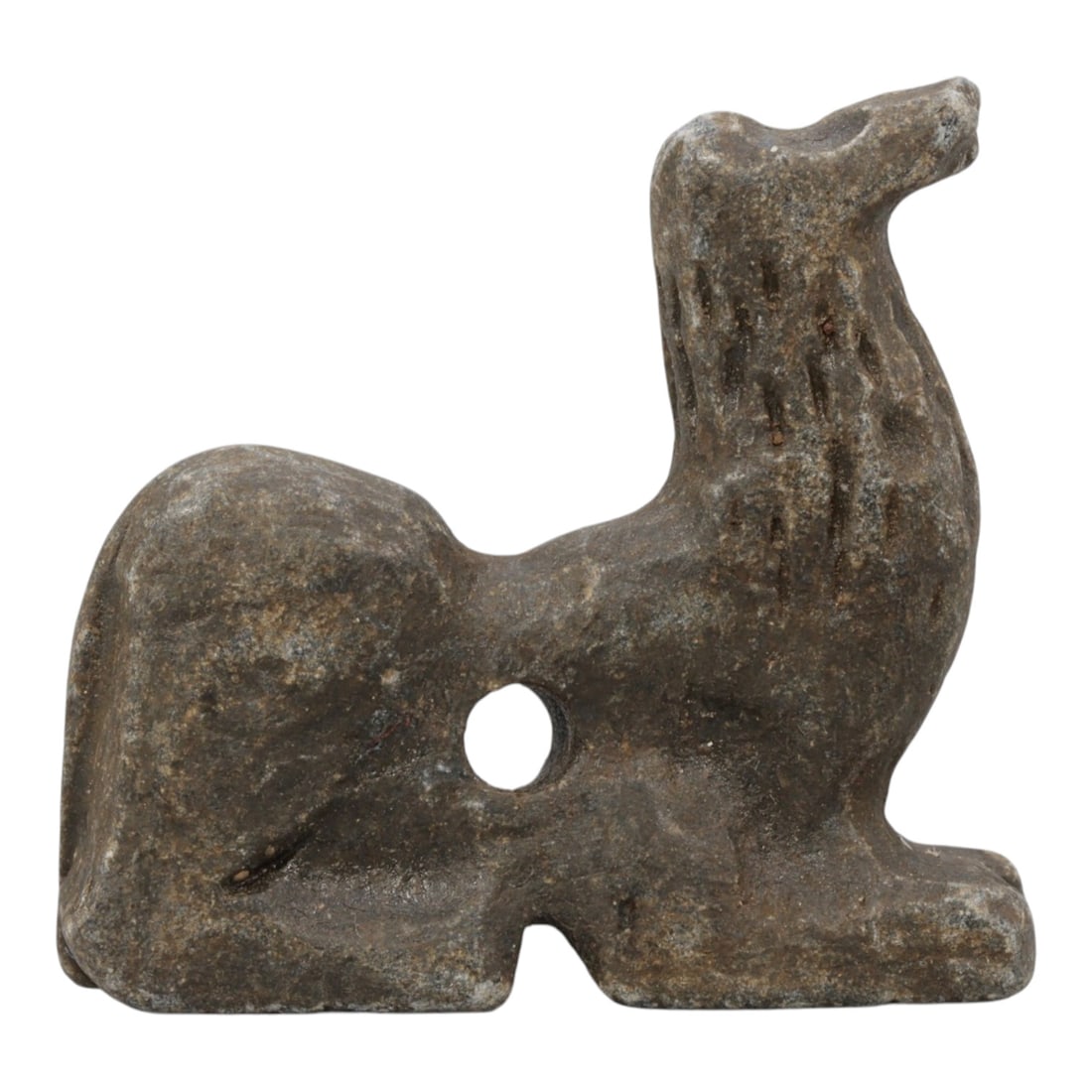 Ancient Near Eastern Style Stone Recumbent Zoomorphic Amulet, 85WM: A single ancient Near Eastern-style stone amulet, carved in the form of a stylized recumbent quadruped (likely a lion or similar feline). The piece features incised linear details on the neck to repre