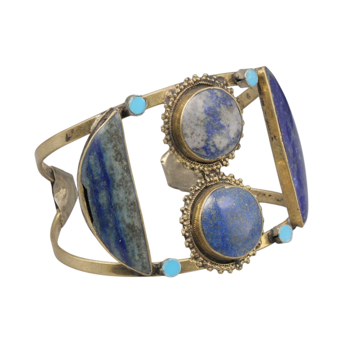 A Vintage Himalayan Lapis Lazuli Stone Inlay Cuff Bracelet, 26AH: A handcrafted vintage cuff bracelet, measuring approximately 7 cm in width, showcasing traditional Himalayan jewelry design. The piece features a brass-toned metal base, with two lapis lazuli stones a