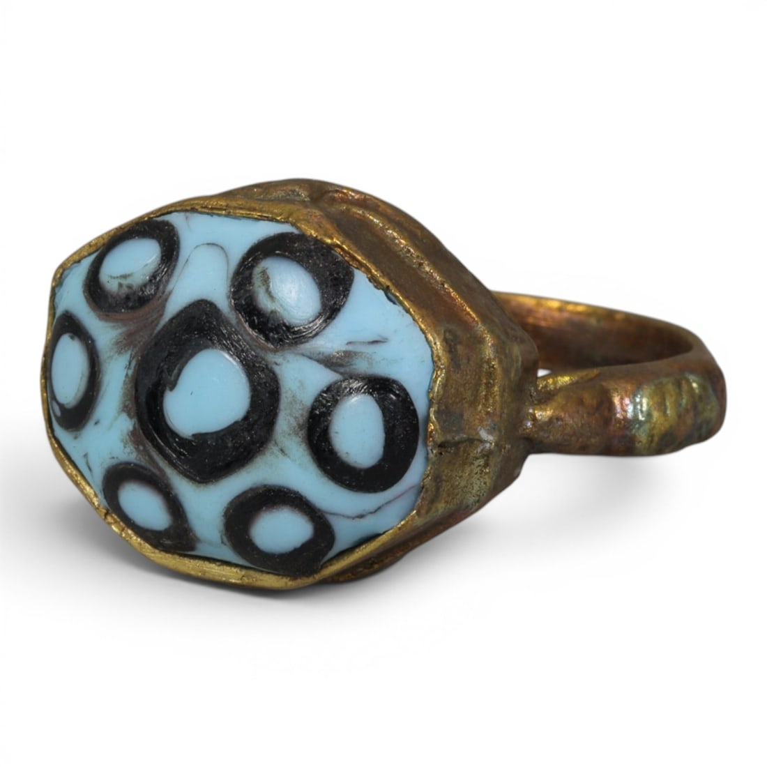 Antique Qajar Dynasty Gilt Evil Eye Ring, US Size 9, 48AJ: A gilt-metal ring of the Qajar period, US ring size 9, featuring an octagonal evil-eye glass inlay with a vibrant light blue base adorned with seven black-and-white concentric eye motifs (one large ce