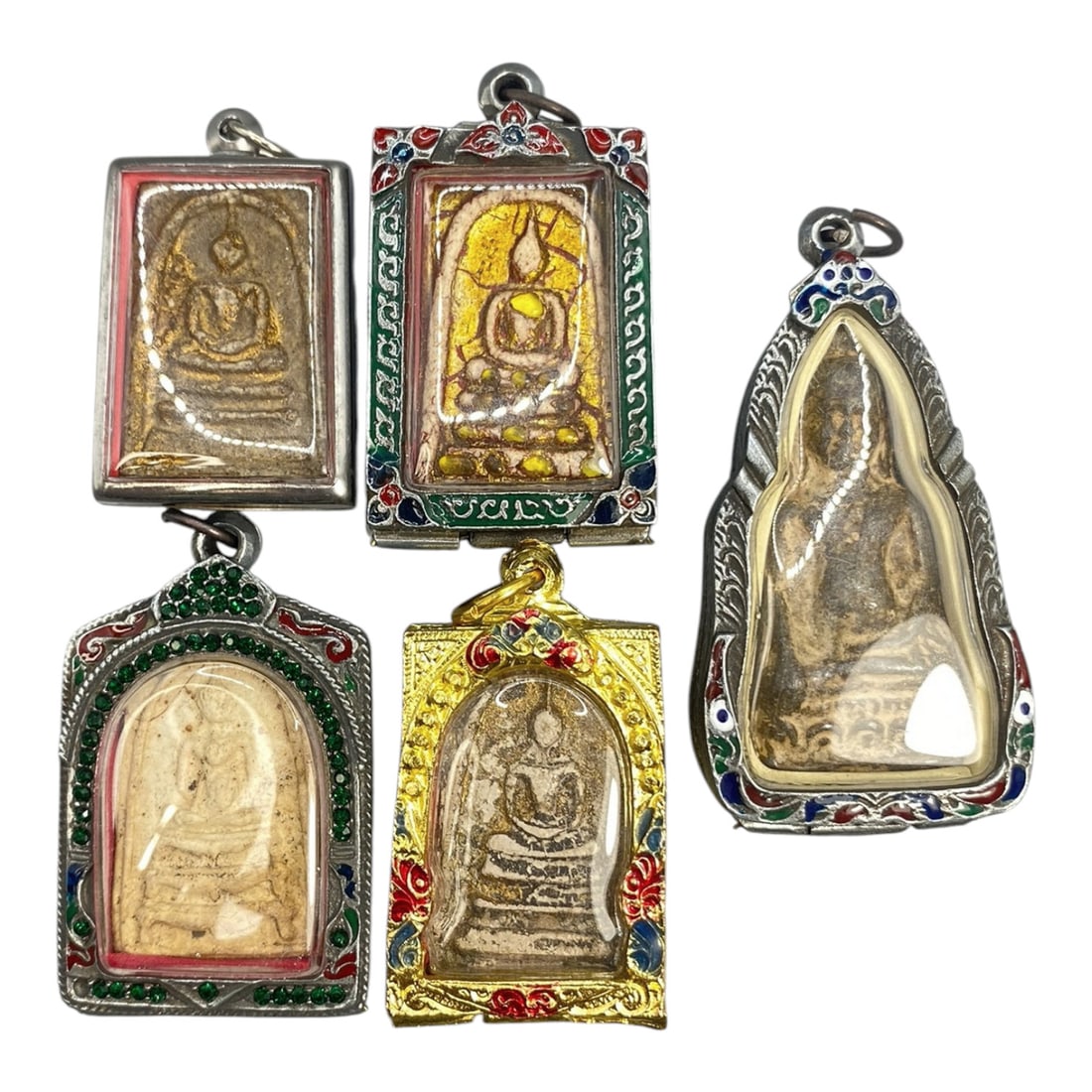 A Lot of 5 Vintage Thai Buddhist Amulets with Enamel and Jewel Accents, 14WT: A curated lot of five vintage Thai Buddhist amulets, each encased in decorative metal frames with enamel detailing and jewel accents. The amulets depict traditional seated Buddha iconography, with var