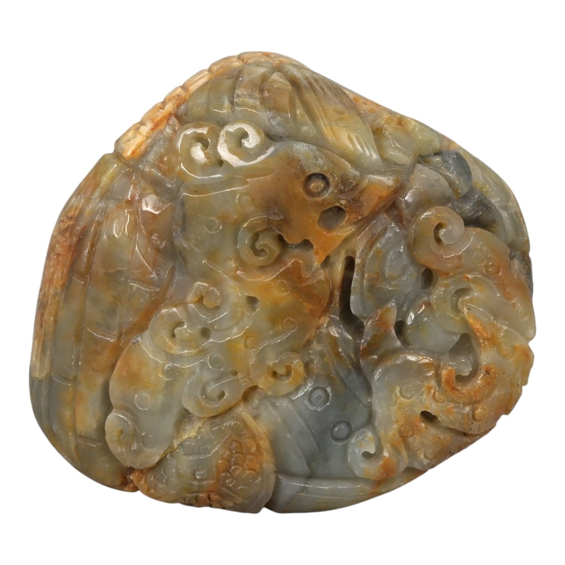 A Chinese Nephrite Jade Dragon Carving, 20th Century, 7YB: Carved from grey-green Hetian nephrite jade with areas of warm brown and russet inclusions, the object is worked as a compact sculptural composition depicting a dragon in relief. The creature is shown