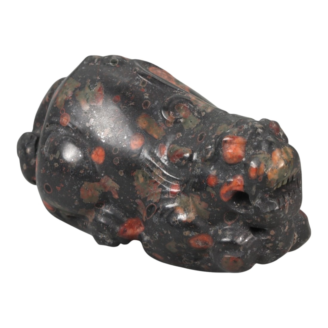 A Chinese Hardstone Carving of a Recumbent Mythical Beast, 20th Century, 91YA: Carved from dense dark hardstone with scattered russet and ochre inclusions, the figure is modeled as a compact recumbent mythical beast with a broad head and rounded body. The animal is shown crouchi