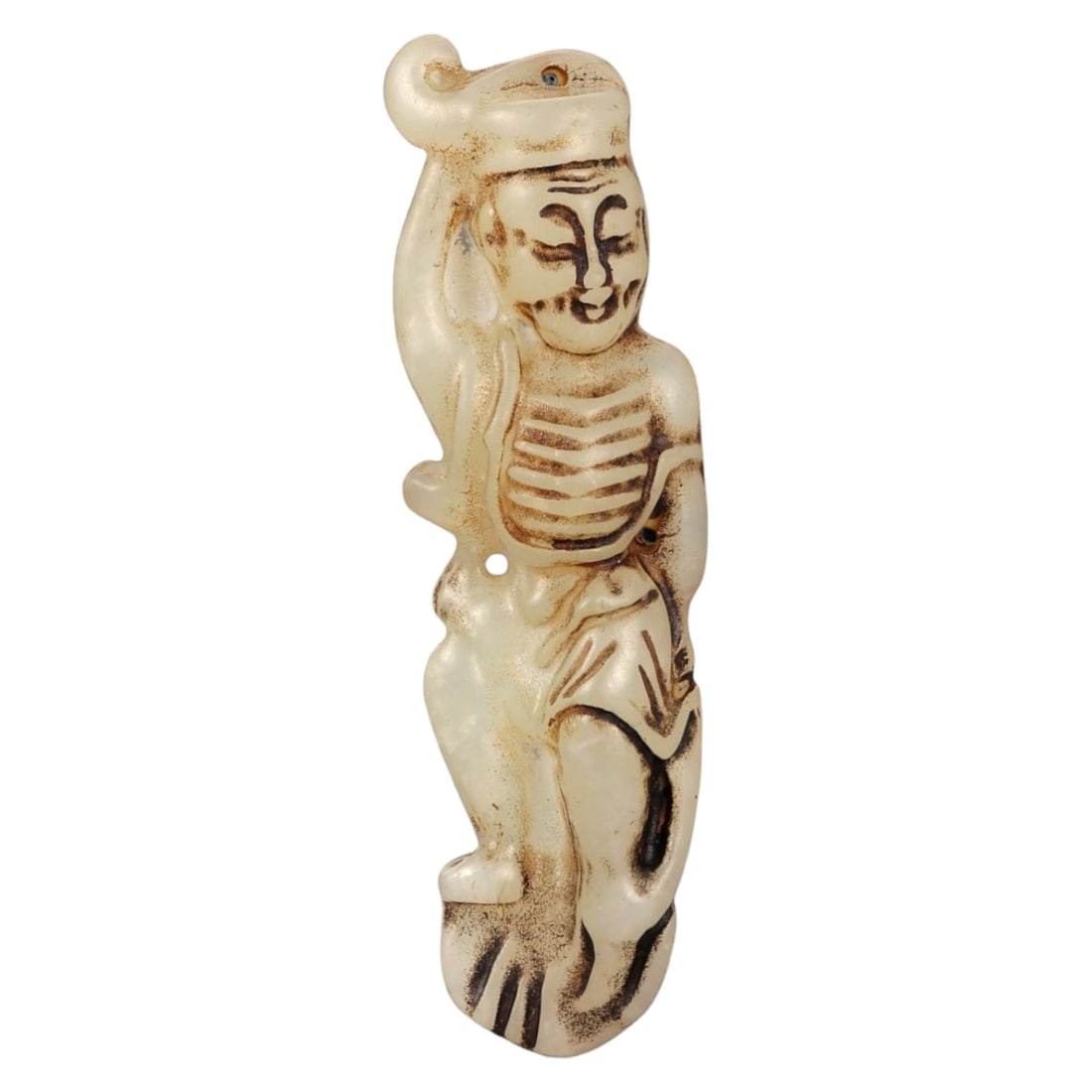 A Chinese Carved Stone Figural Pendant, 20th Century, 53FA: Carved from pale cream-colored stone with darker brown surface staining accentuating the incised details, the pendant depicts a standing human figure rendered in a simplified, elongated form. The figu