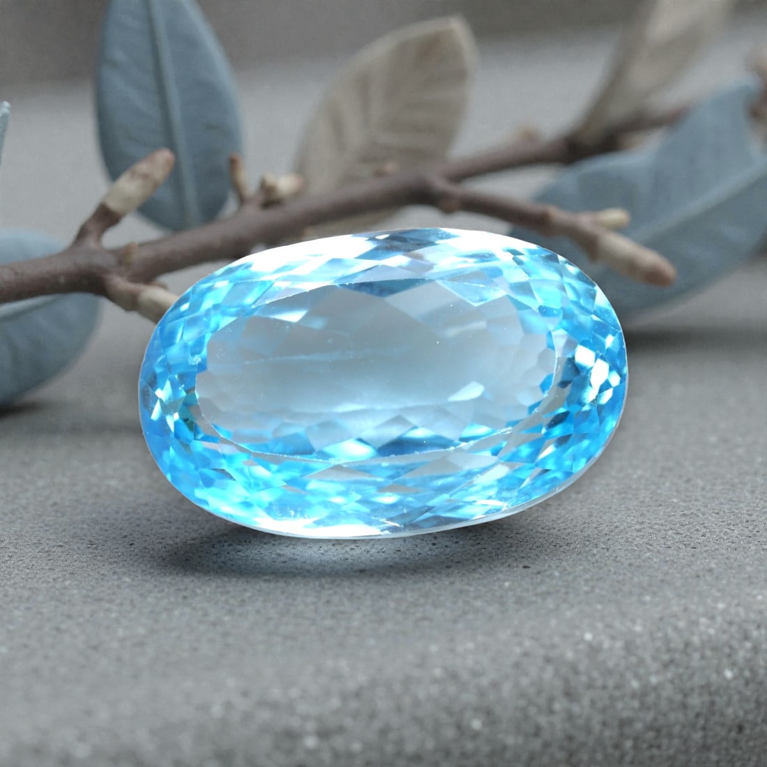 52.82 Carats Swiss Blue Topaz Oval - Natural Brazilian Stone, LZ107: This magnificent oval-cut Swiss blue topaz is a true statement gem, boasting a vivid, saturated sky-blue hue that radiates clarity and light. Its expertly faceted cut features precisely angled surface
