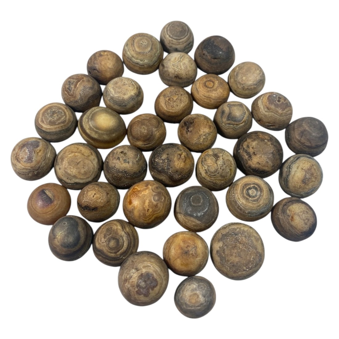 Lot of 37 Antique Tibetan Luk Mik Goat Eye Agate Beads, 42AC: A collection of thirty-seven spherical agate beads, known as luk mik or goat eye beads, each exhibiting natural concentric banding patterns in earthy tones of brown, grey, and tan. Many examples displ