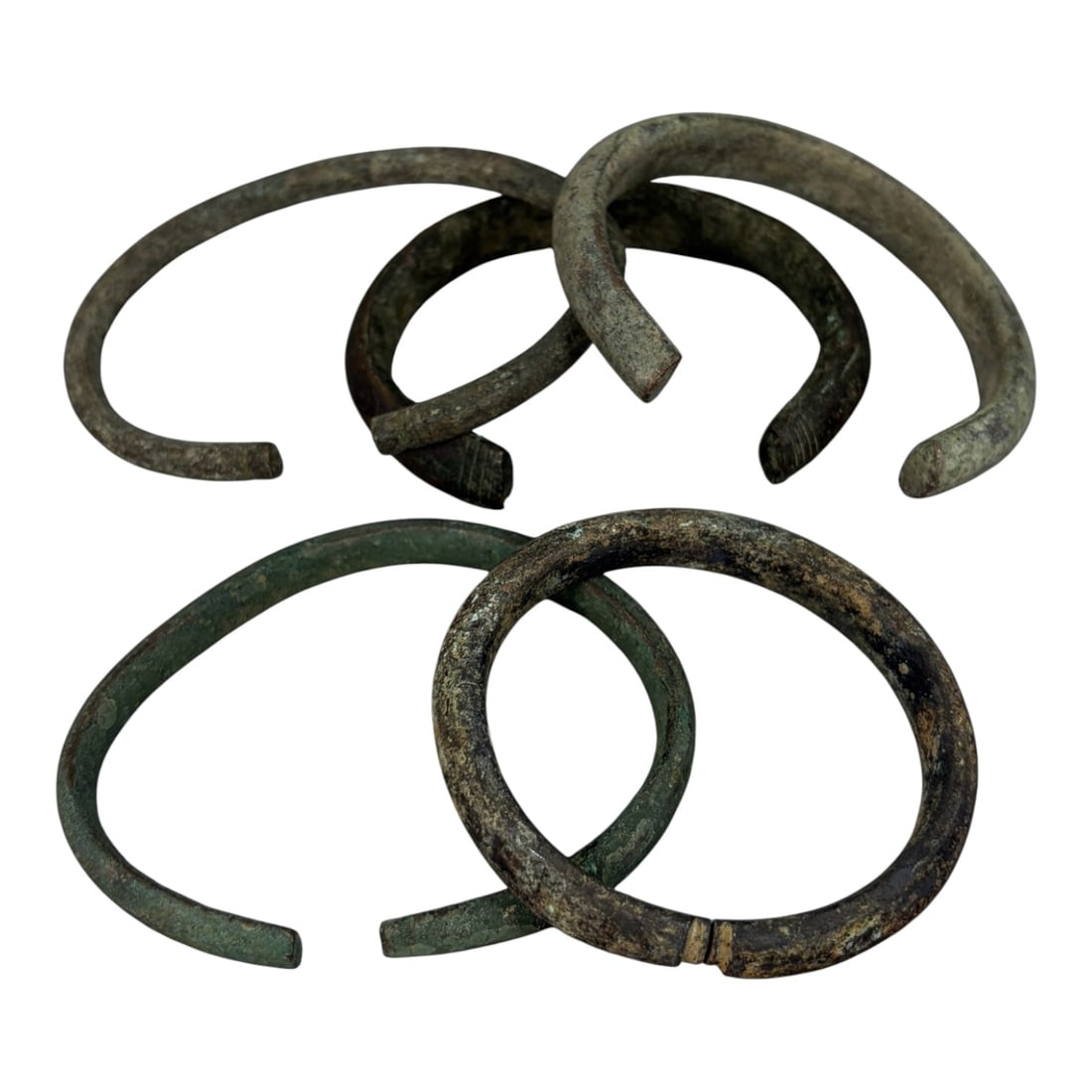 Lot of 5 Roman Bronze Bracelets, Circa 1st-4th Century CE, 90AG: A group of five open-ended bracelets crafted from bronze, exhibiting varied patination including deep green verdigris, dark brown oxidation, and lighter greyish surface deposits, consistent with long-