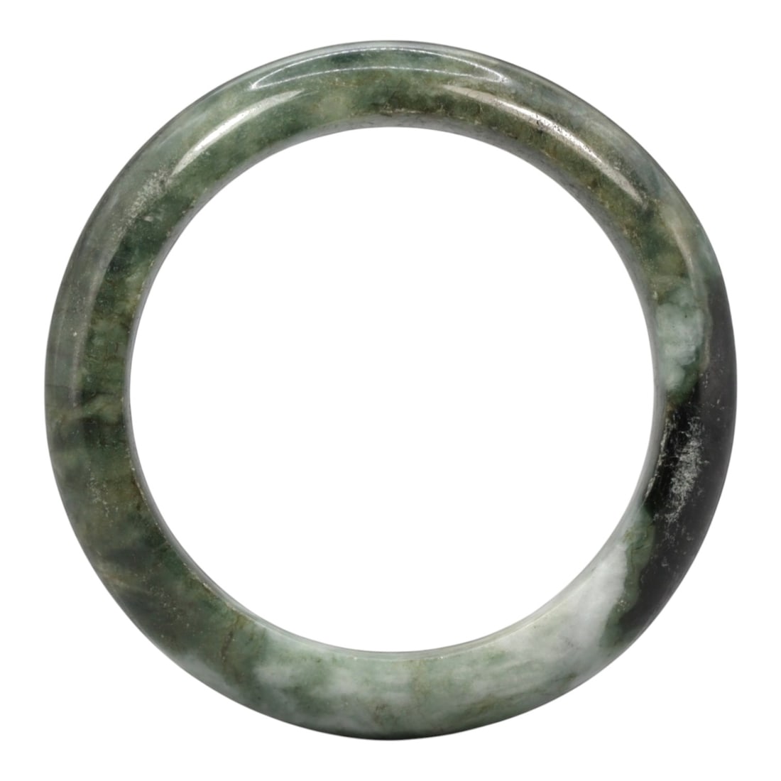 A Chinese Jadeite Jade Bangle Bracelet, 20th Century, 2ZL: Carved from jadeite jade with a variegated palette of pale green and deep blackish-green mottling throughout, the bangle is formed as a continuous circular band with a rounded cross-section. The surfa