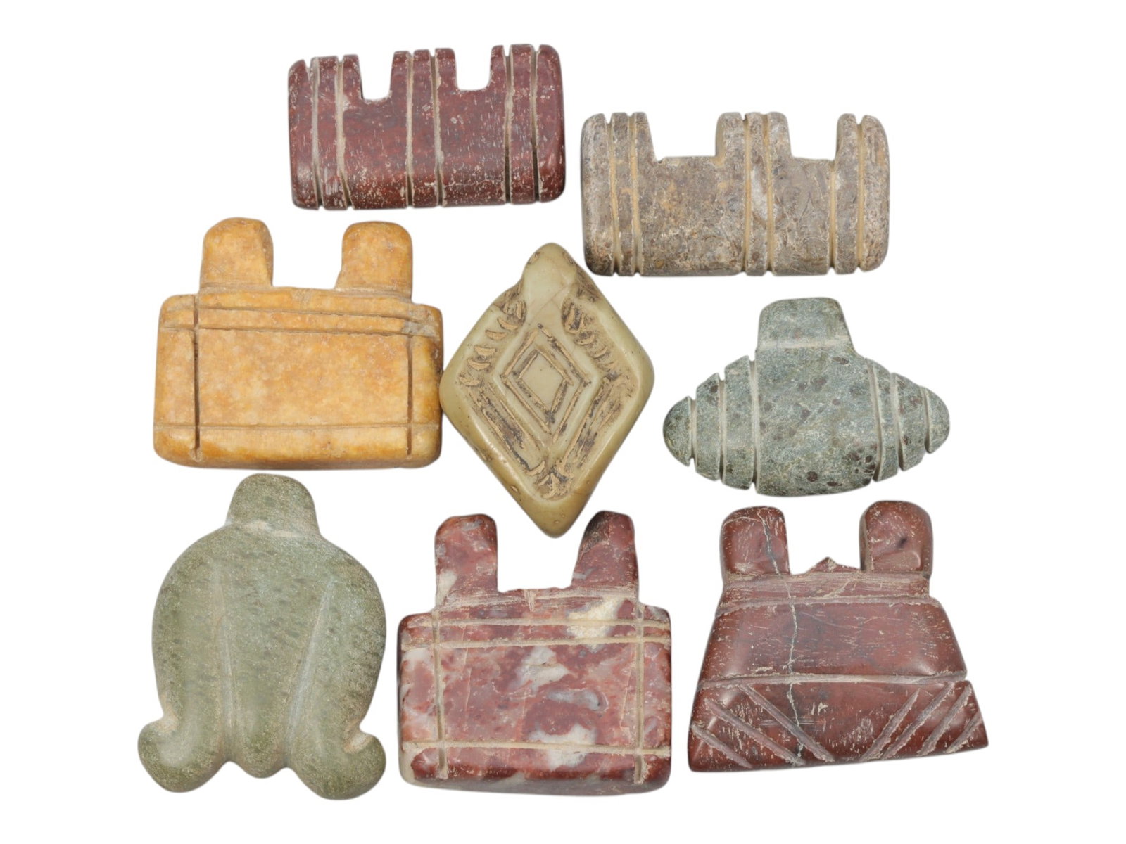 Lot of 8 Ancient Coptic Egyptian Multi-Stone Amulets, Circa Roman to Coptic Era, 63WT: Carved from various earth-toned stones including red marble, yellow stone, grey stone, and green stone, the group consists of eight distinct amulets, ranging in size from 2 cm to 3 cm (0.79-1.18 in.).