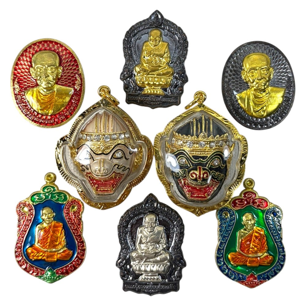 A Lot of 8 Vintage Gilt Thai Buddhist Amulets with Enamel Accents, 23AA: Comprising eight pendants ranging from 4 to 5 cm in height. The collection features a mix of revered monastic portraits, including both gilt and silver-toned reliefs, alongside two ornate enamel-faced