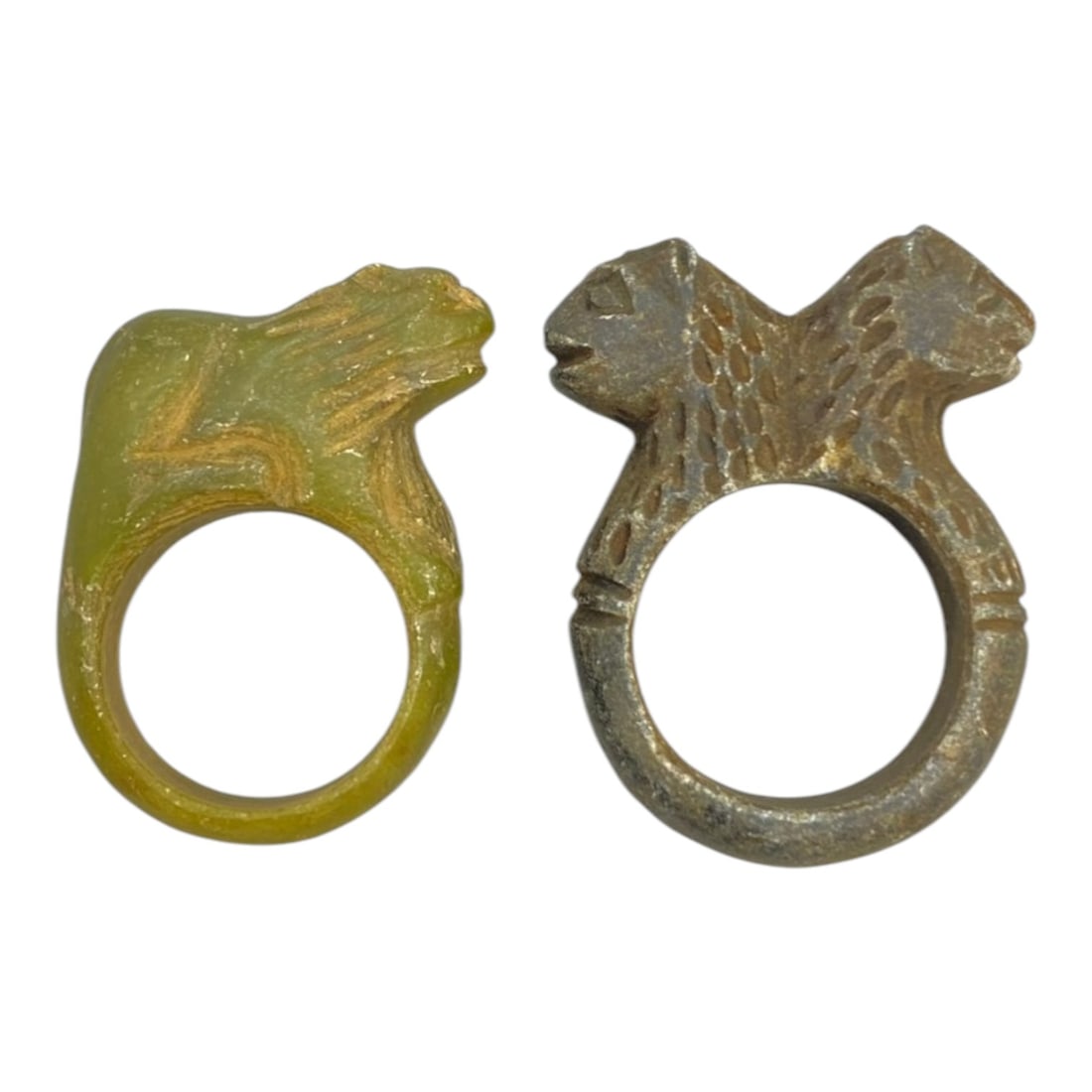 Pair of Ancient Near Eastern Carved Stone Lion Amulet Rings, 63WK: This pair of rings is hand-carved from stone, with two distinct styles:Single Lion Ring (US Size 8-9): Crafted from translucent green stone, featuring a detailed profile lion head and mane carved atop
