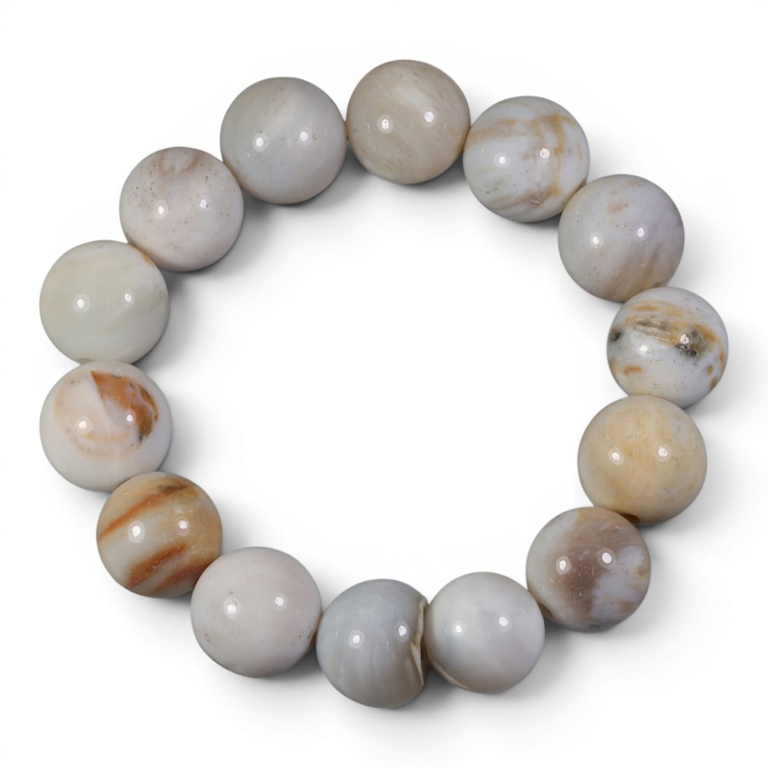 Natural Burmese Fossilized Wood Beaded Bracelet, 2AK: Come take a look at this one-of-a-kind fossilized wood bracelet, a little piece of ancient history you can wear! This bracelet has a comfortable 56mm diameter, strung with smooth, polished round beads