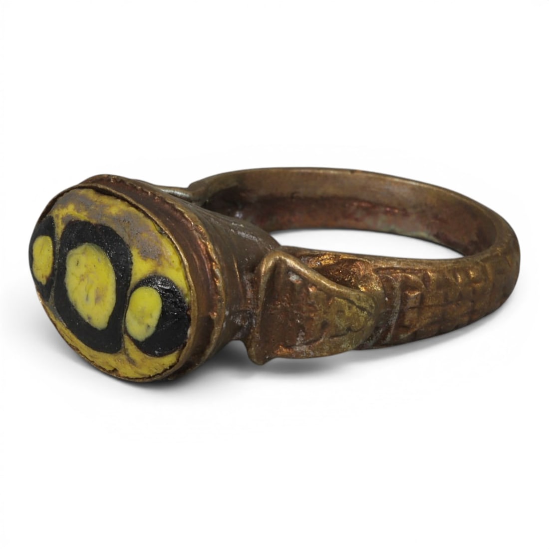 Antique Qajar Dynasty Gilt Evil Eye Ring, US Size 9, 8AJ: A gilt-metal ring of the Qajar period, US ring size 9, featuring an oval evil-eye glass inlay with a vibrant yellow and black multi-eye motif. The domed bezel is adorned with embossed geometric and fl