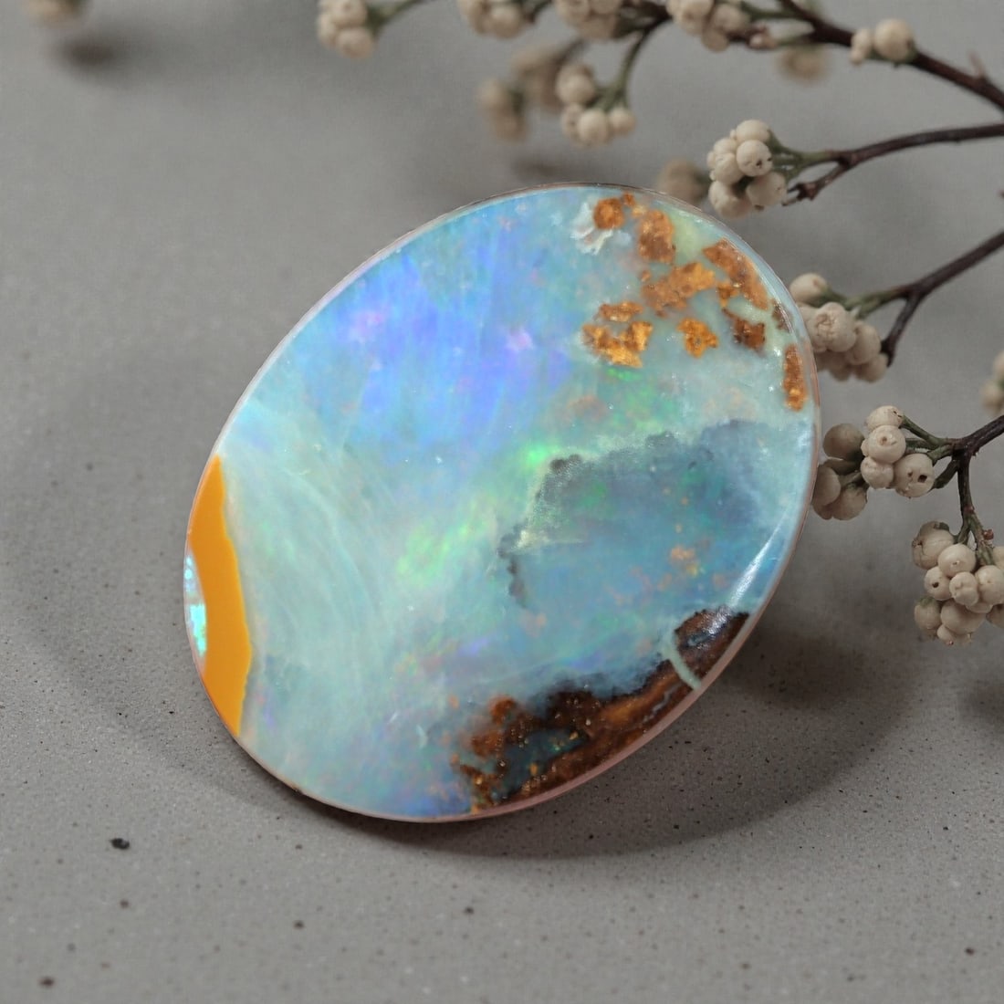 2.36 Carats Pastel Blue Winton Boulder Opal - Natural Australian Stone, LZ40: This breathtaking 2.36 carat Winton boulder opal is a miniature natural landscape, polished into an elegant oval cabochon measuring 10.8mm x 8.4mm x 2.8mm. Its broad face displays a soft, milky opal f
