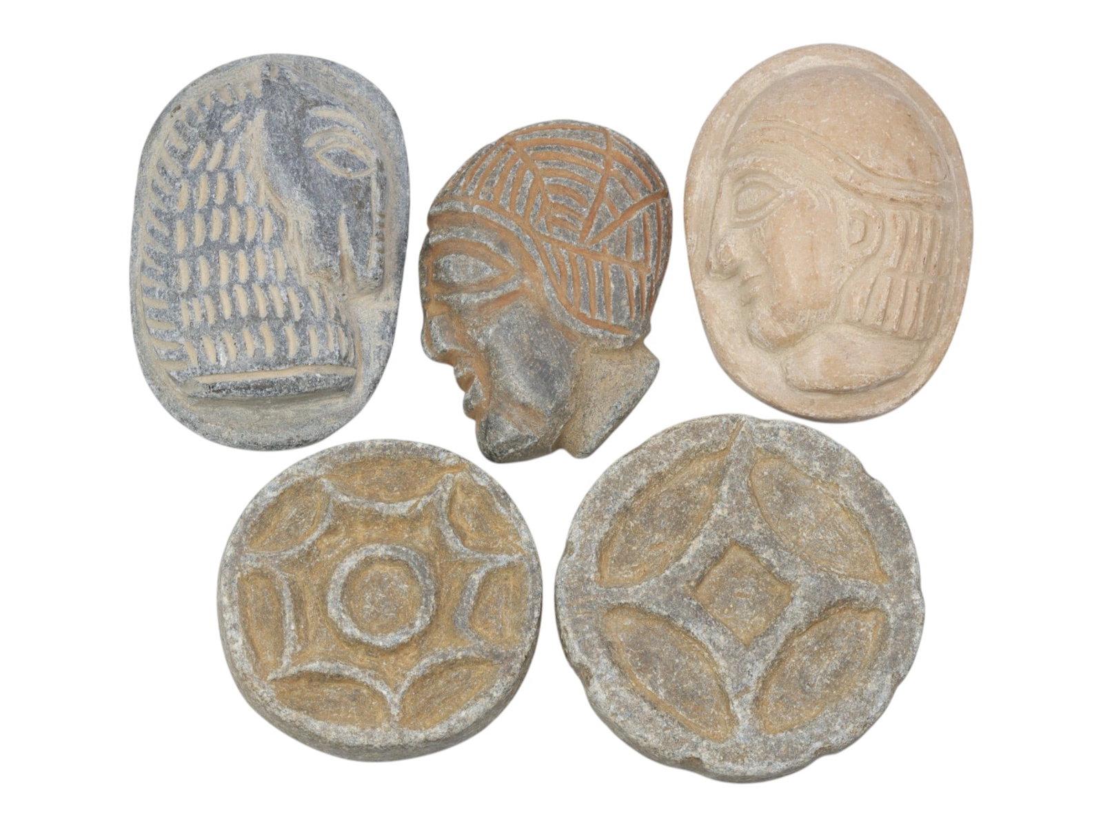 Lot of 5 Ancient Near Eastern Stone Relics, Circa Late Bronze to Iron Age, 4WS: Carved from various stones in grey and light beige tones, the group consists of five distinct relics. The set includes three pieces with anthropomorphic profile bust motifs (two flat oval plaques, one