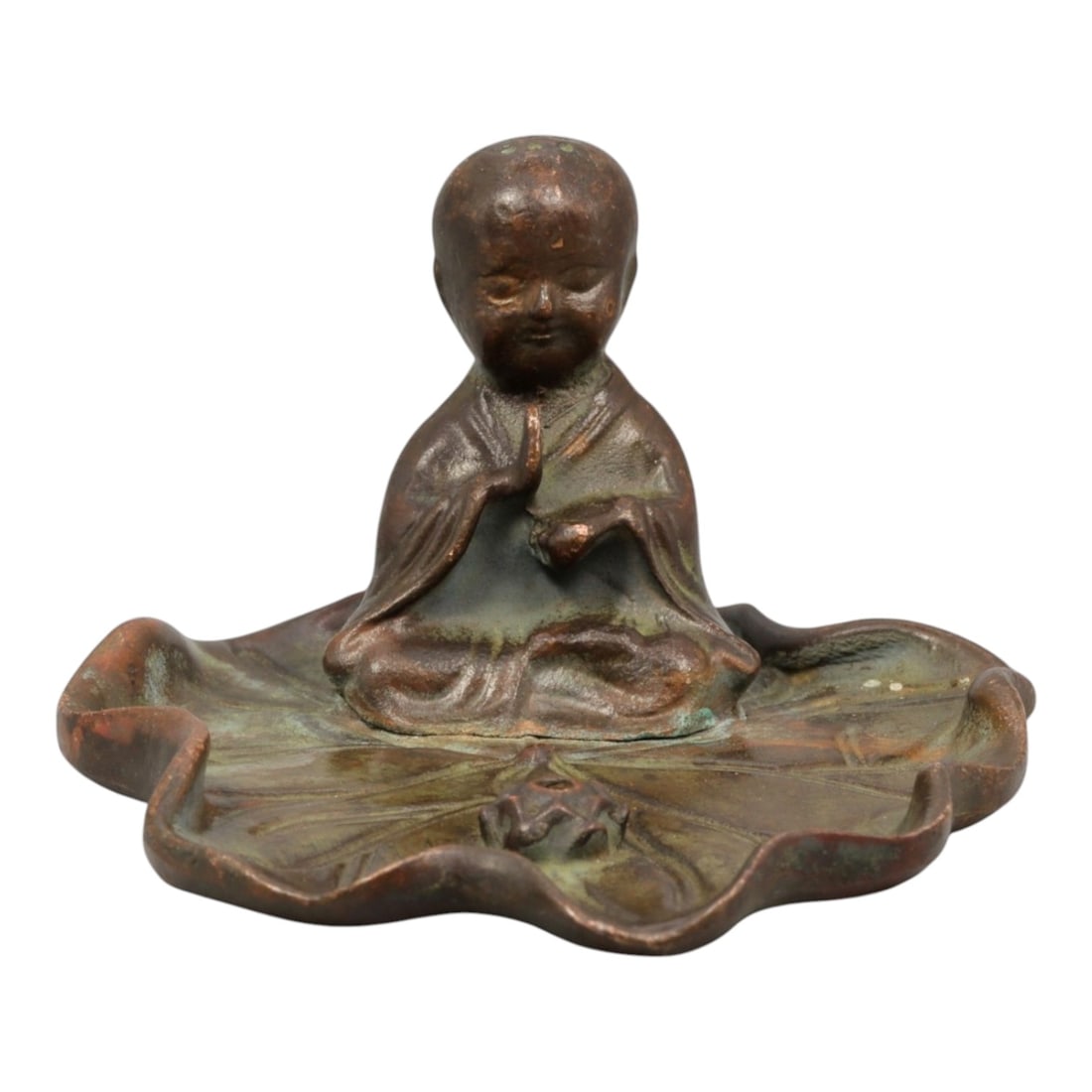 A Chinese Bronze Figure of a Meditating Monk on a Lotus Base, 20th Century, 77YC: Cast in bronze, the figure represents a seated meditating monk shown cross-legged atop a stylized lotus-form base. The figure is modeled with a rounded head, softly defined facial features, and downca